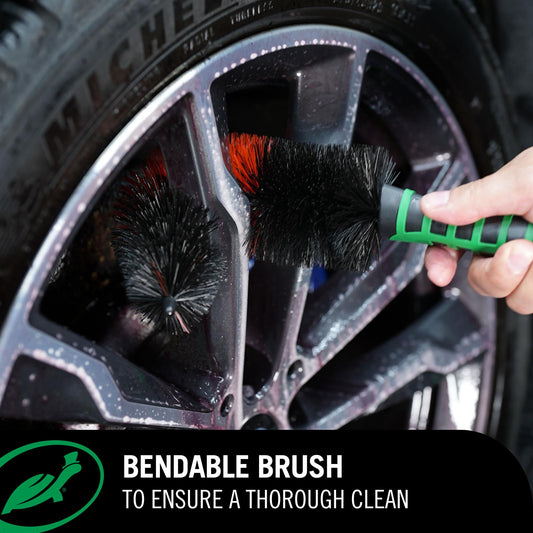 Car wheel being cleaned with a Red Line Wheel Brush, with Michelin tire in the background.