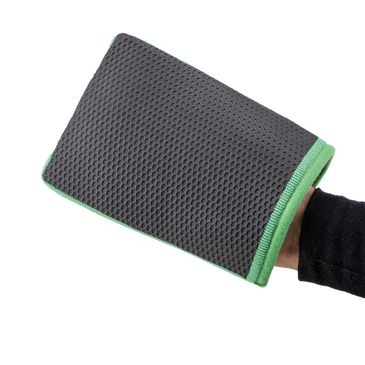 Textured grey vehicle cleaning mitt with green trim, held by a hand.