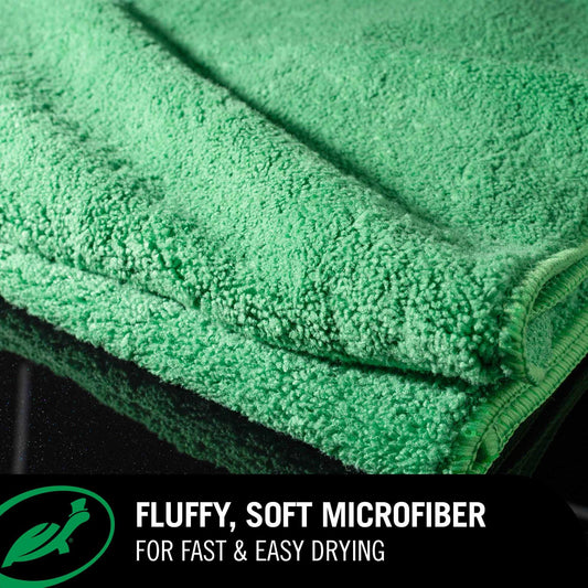 Green Jumbo Drying Towel with text highlighting its fluffy, soft microfiber properties on a black background