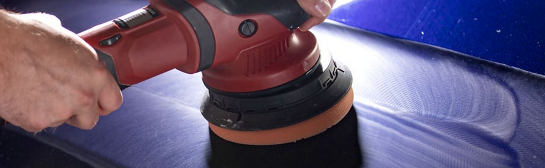 Image showing a man using a car polishing machine on a blue car