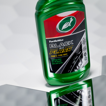 Turtle Wax Black in a Flash Trim & Tyre Wax in a green bottle. Ideal for lasting shine on plastic trim and tyres.