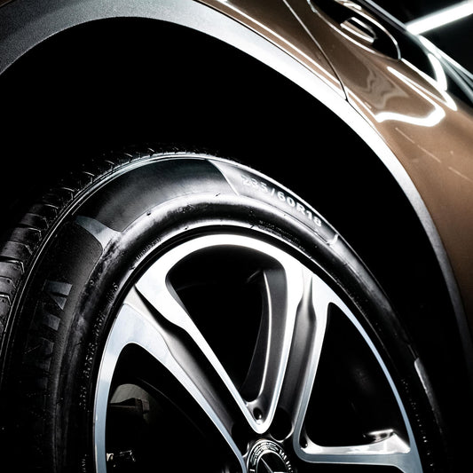 Close-up of a car wheel and tyre with a glossy, freshly-cleaned finish. Modern alloy design. Car detailing.