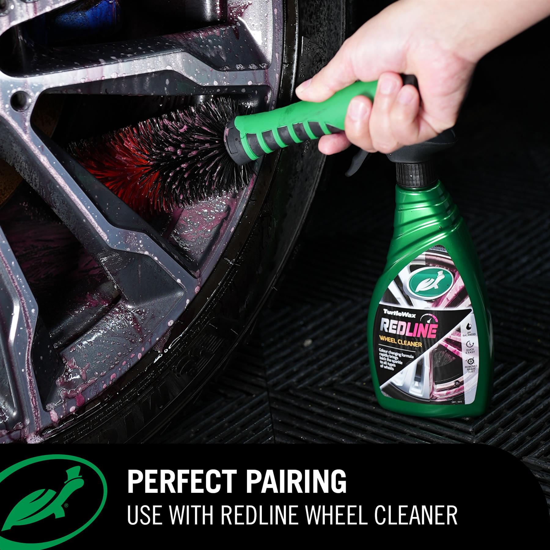 Person cleaning car wheel with Red Line Wheel Brush and bottle of RedLine wheel cleaner