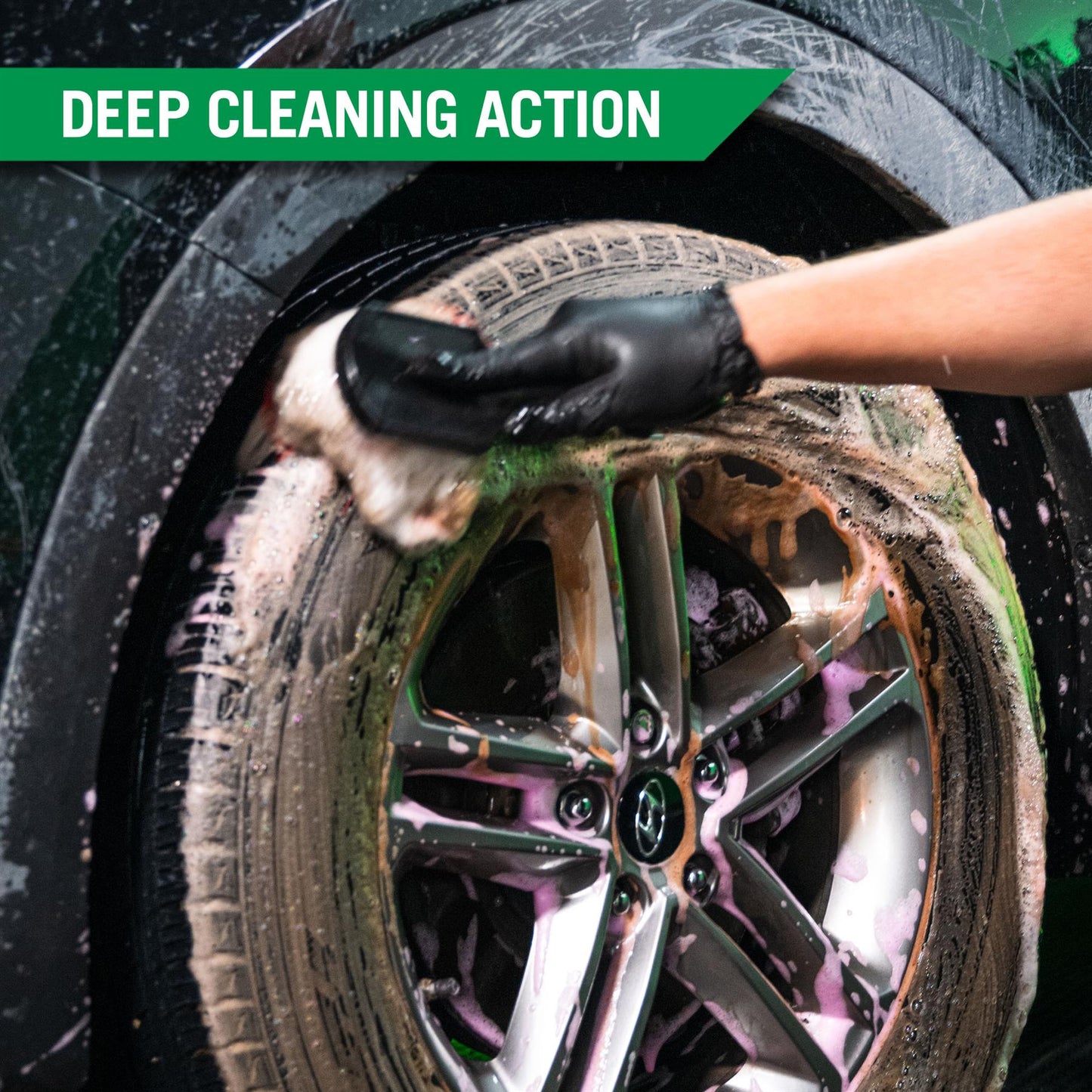 Wheels are washed using a mitt with foam. Car detailing shows clean alloys and tyres. Deep cleaning action is occurring.
