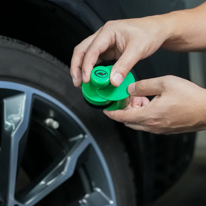 Applying tyre shine with a Turtle Wax applicator. A green detailing tool is shown to give car tyres a brilliant finish.