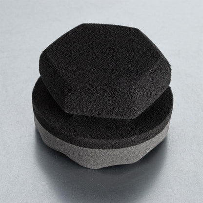 Car detailing: stacked foam applicators. One hexagon-shaped, the other round with grey side.