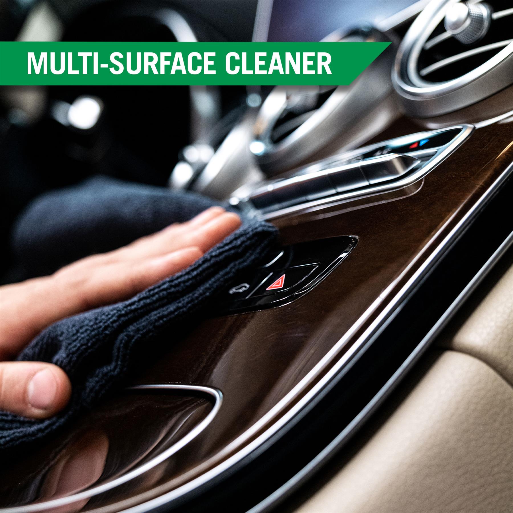 Cleaning a car's interior. Wiping a wood-grain trim with a cloth. Car detailing essentials.