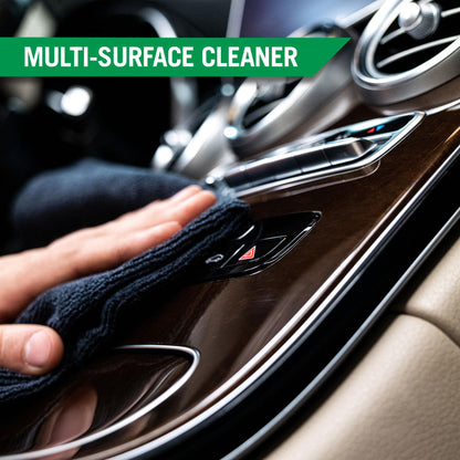Cleaning a car's interior. Wiping a wood-grain trim with a cloth. Car detailing essentials.
