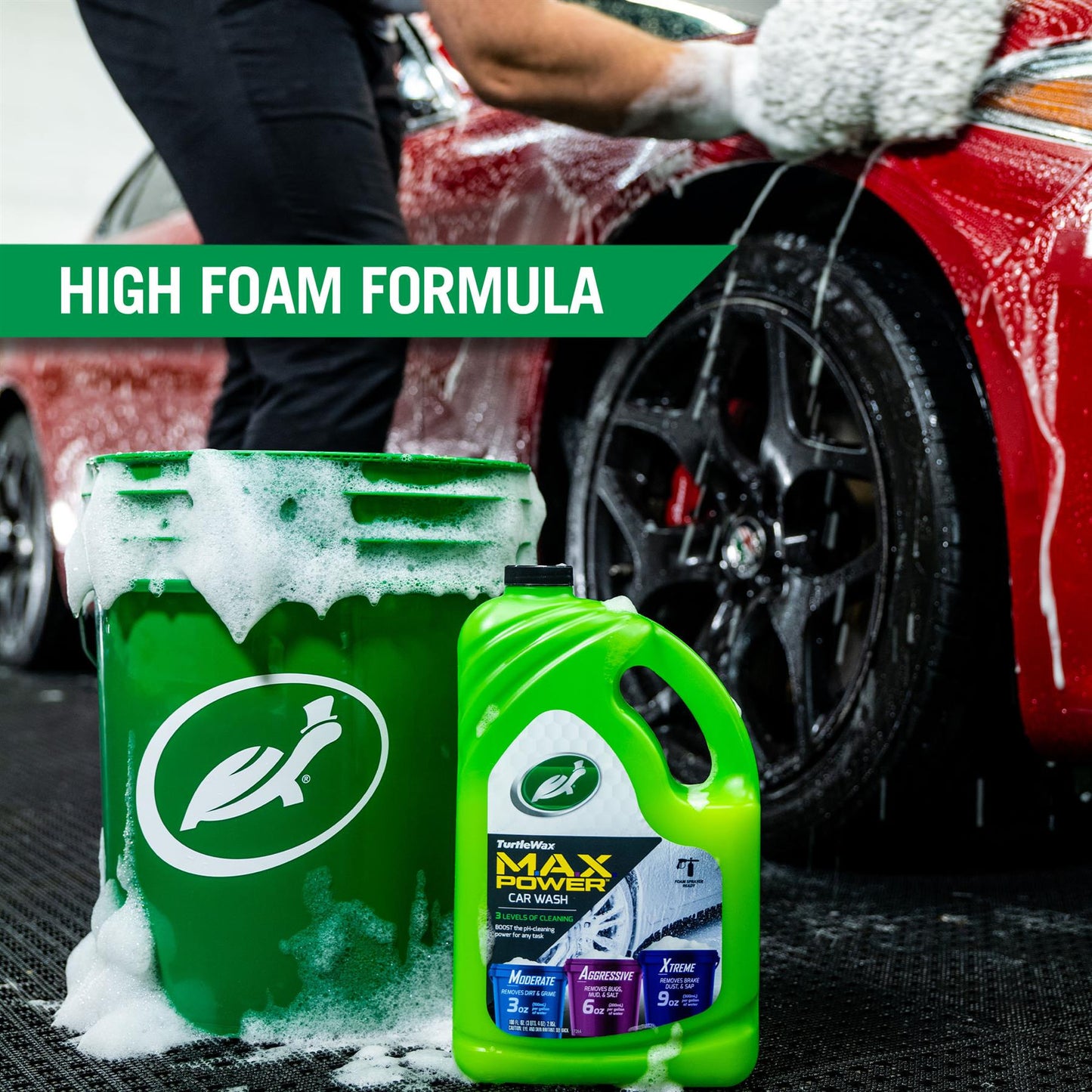 Turtle Wax car wash with high foam formula being used on a red motor, displayed with a bucket and concentrated liquid.
