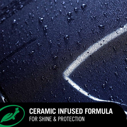 Close-up of a car surface with water droplets and a ceramic infused formula label.