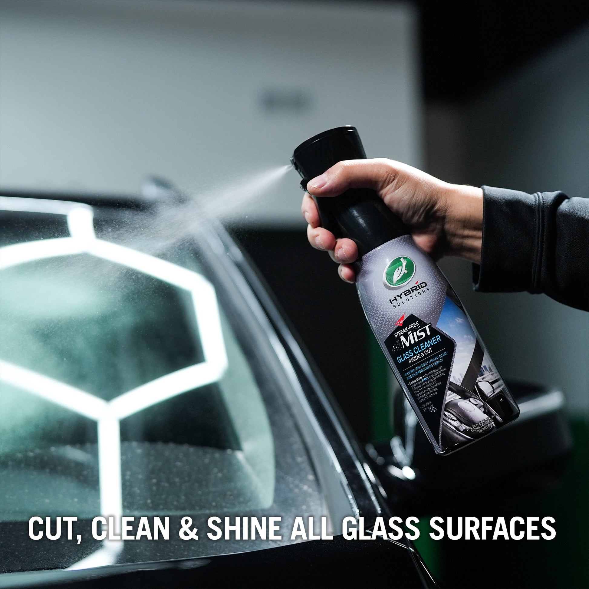 Turtle Wax Hybrid Solutions Streak-Free Mist being sprayed onto a car windscreen.  For cleaning car windows and interiors.
