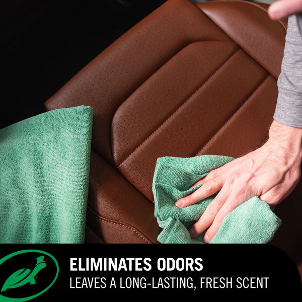 Person cleaning a car seat with a green cloth, emphasizing odor elimination and fresh scent.
