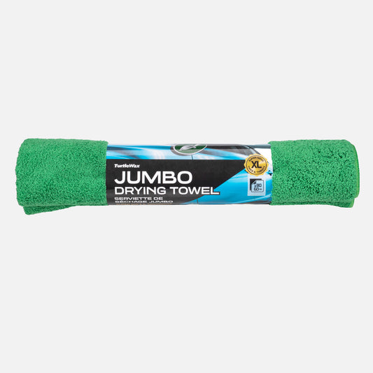 Green jumbo drying towel with packaging on a grey background