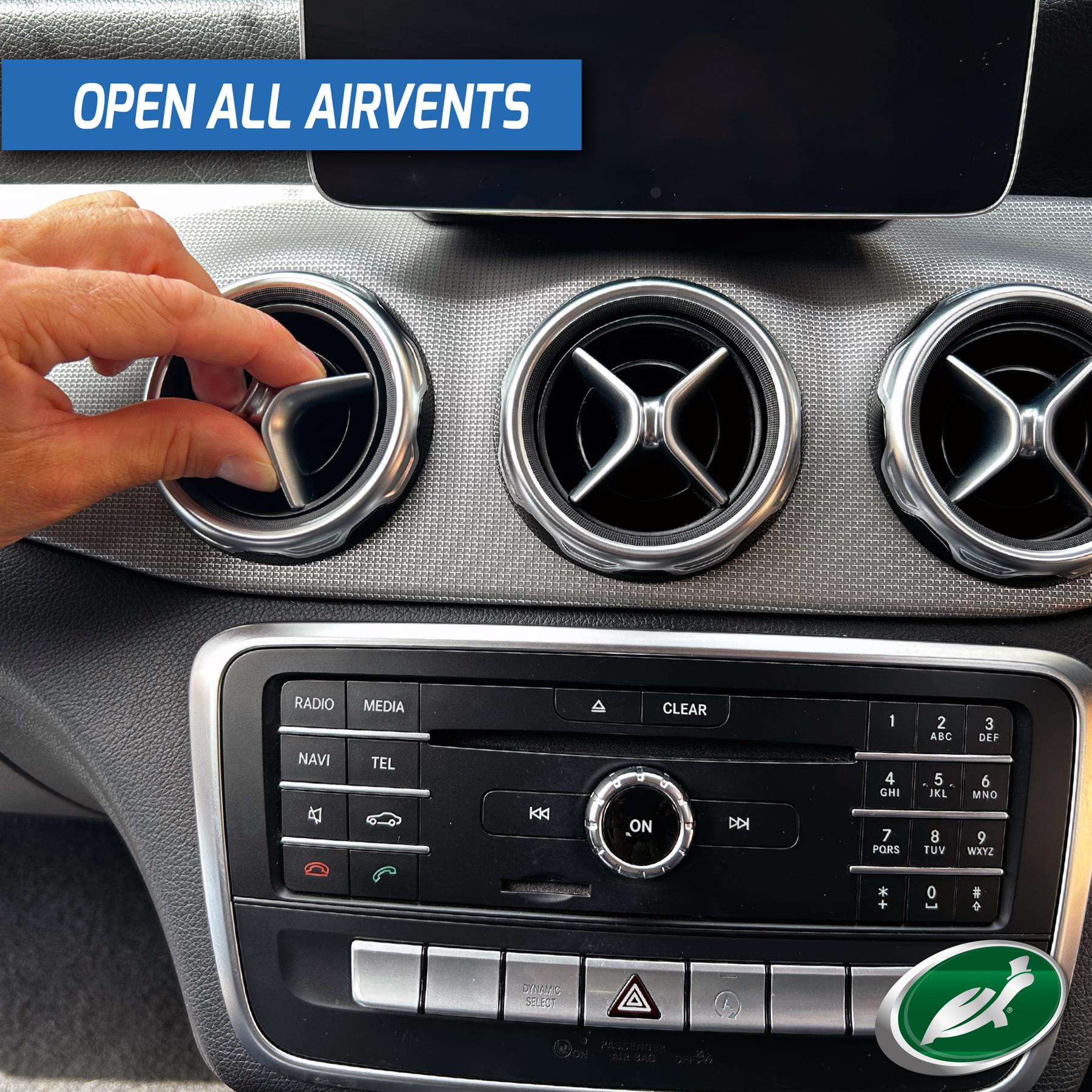 Car interior detail: adjusting vent for Turtle Wax freshener. Ventilation system focus.