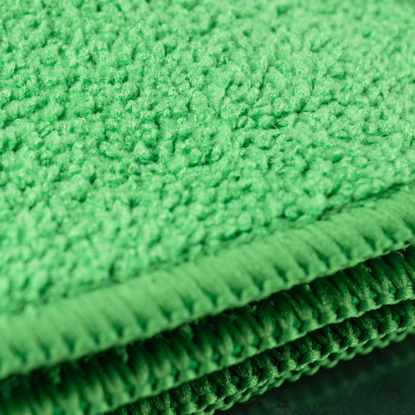 Close-up of bright green, absorbent, microfibre cloths. Ideal for cleaning tasks.