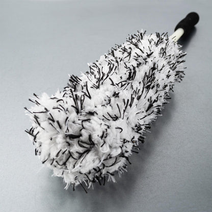 Fluffy car detailing brush. Soft, white wool with black accents and a long handle for reaching tight spaces.
