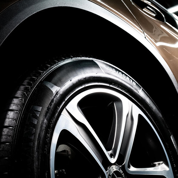 Close up of a shiny and high gloss black finish on the tire of a car. 