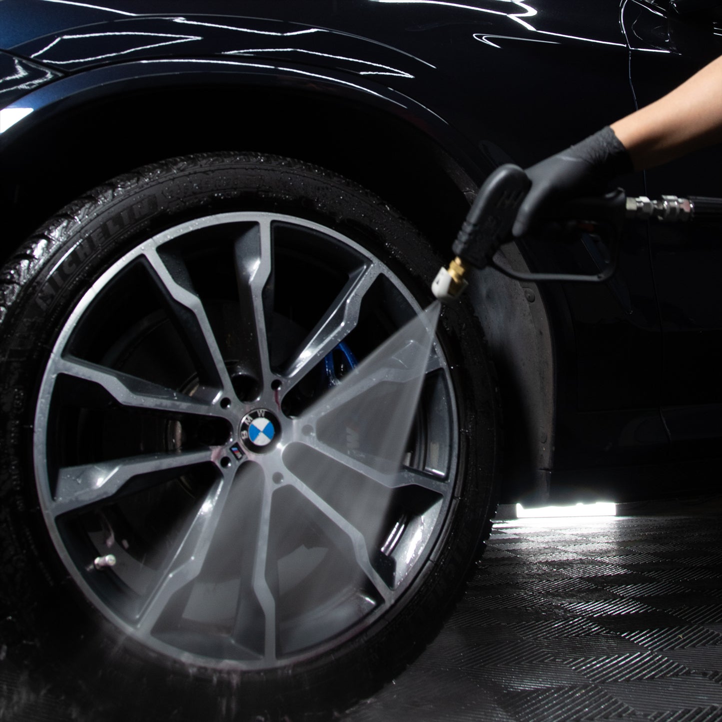 Detailing BMW alloy wheel with spray. Car care.
