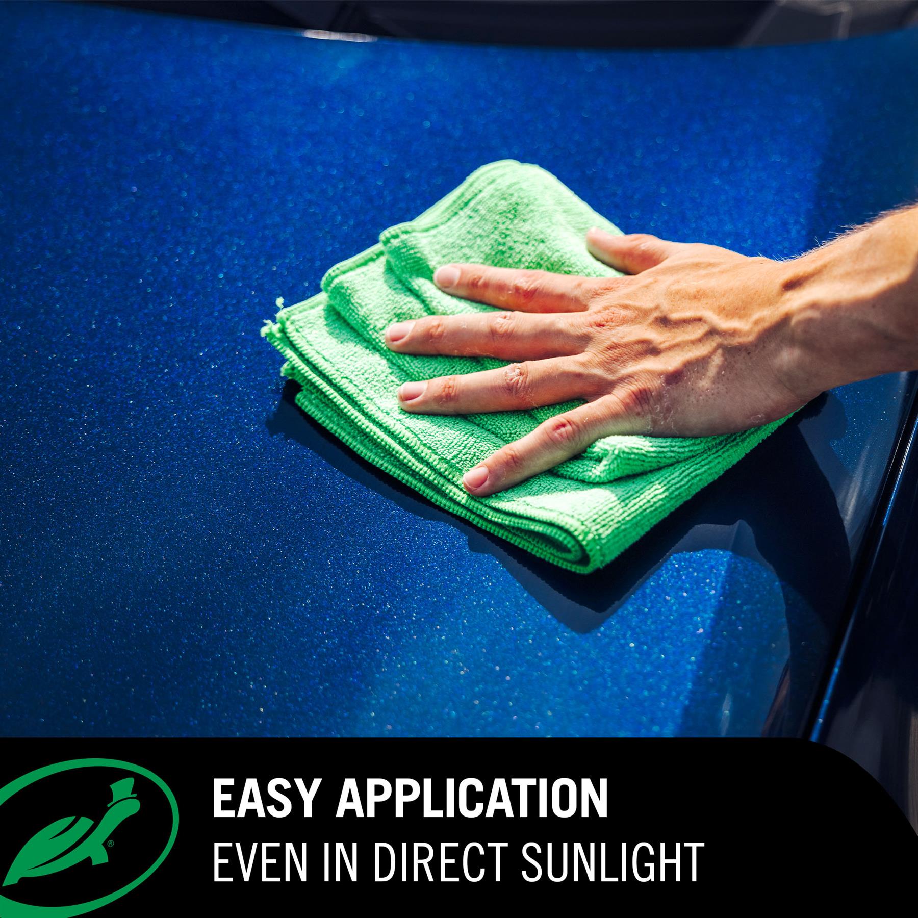 Hand using a green microfiber cloth to clean a blue car surface with text 'Easy Application Even in Direct Sunlight'.