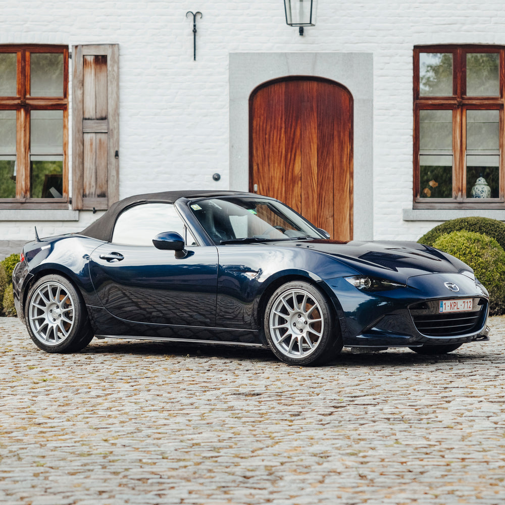 Blue car parked in front of house 
