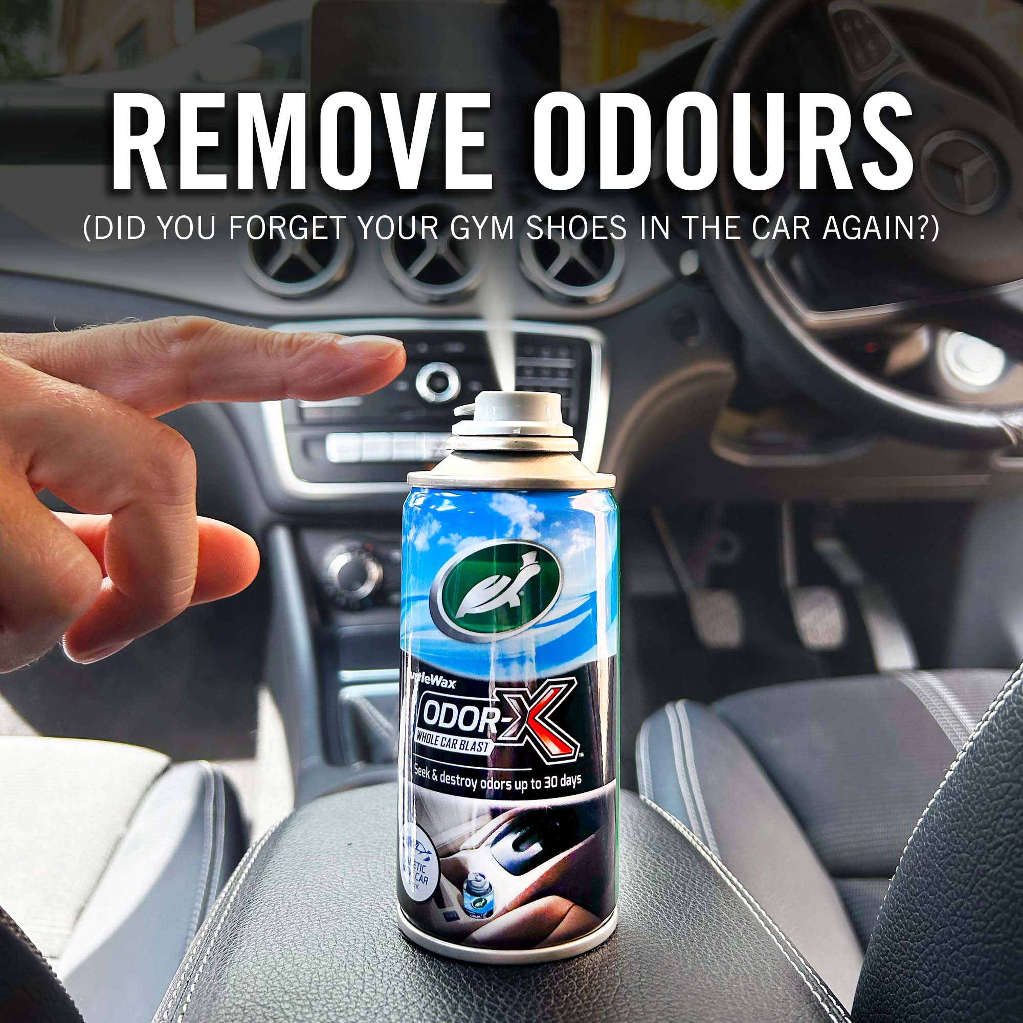 Can of Odor-X air freshener spray held by a hand inside a car, with text about removing odors.