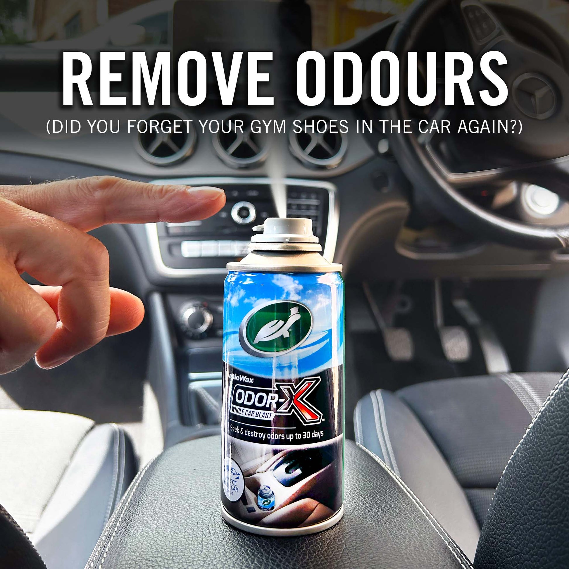 Can of Odor-X air freshener spray held by a hand inside a car, with text about removing odors.