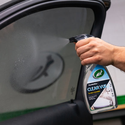 Turtle Wax ClearVue Glass Cleaner being sprayed onto a car window. Streak-free for a sparkling clean.