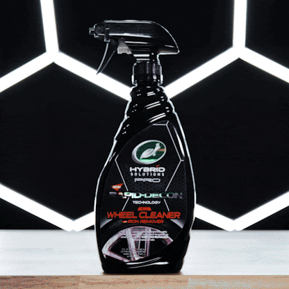 Turtle Wax Hybrid Solutions Pro wheel cleaner with iron remover, shown in black bottle with spray nozzle. Car detailing product.
