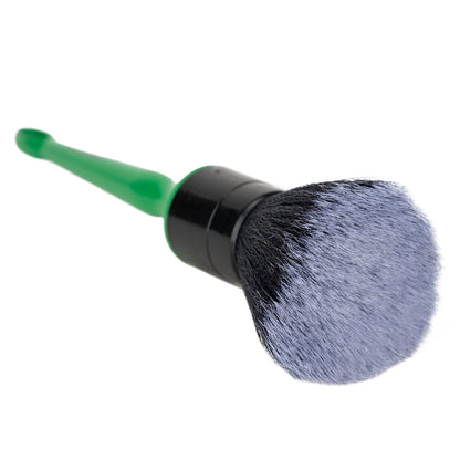Car detailing brush with a green handle and dark bristles. Perfect for cleaning interiors.