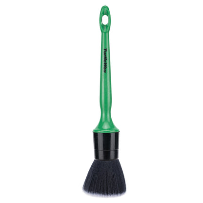 A Turtle Wax car detailing brush with black bristles and a green handle, displayed on a white background.