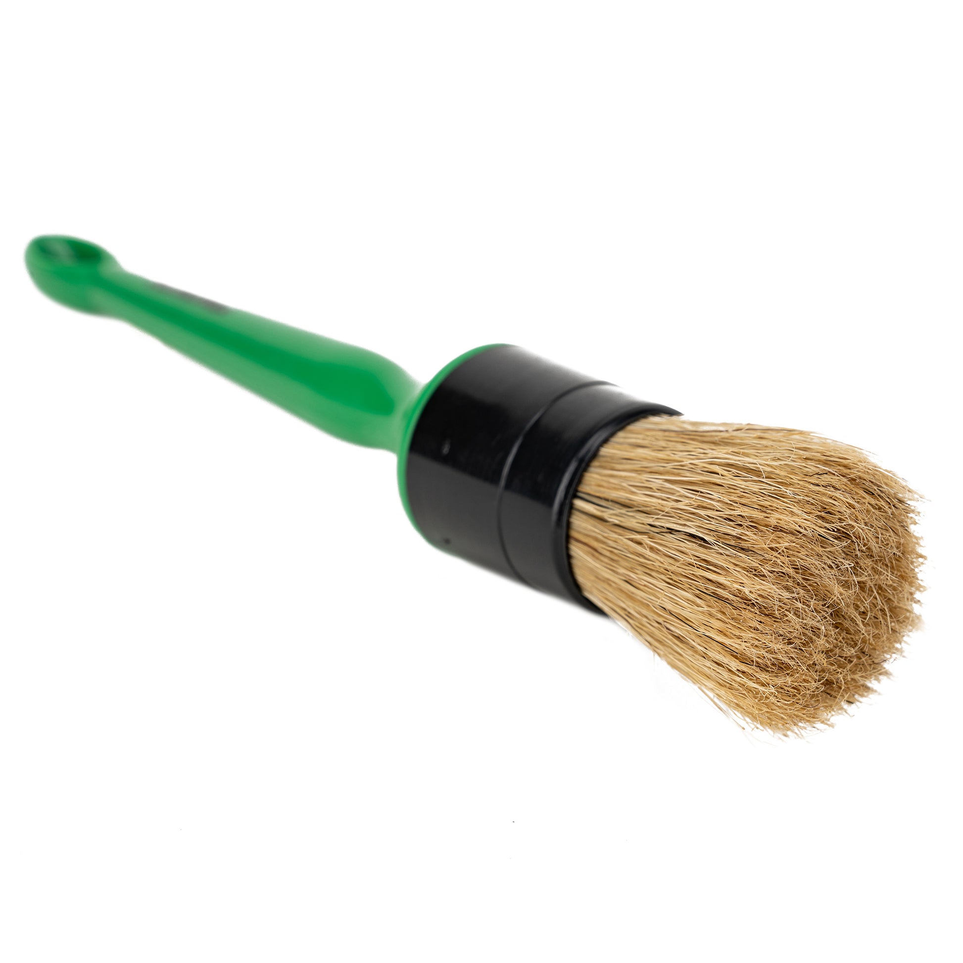 Detailing brush with a green handle and natural bristles. Car cleaning tool.