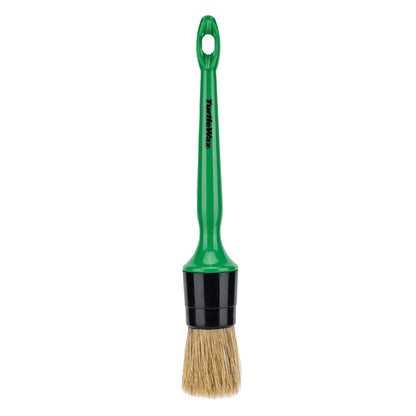 Turtle Wax detailing brush with a green handle. Tool with bristles for car interior cleaning.