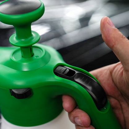 Close-up of green foaming sprayer with ergonomic handle and pressure release valve. Ideal for car detailing & cleaning.

