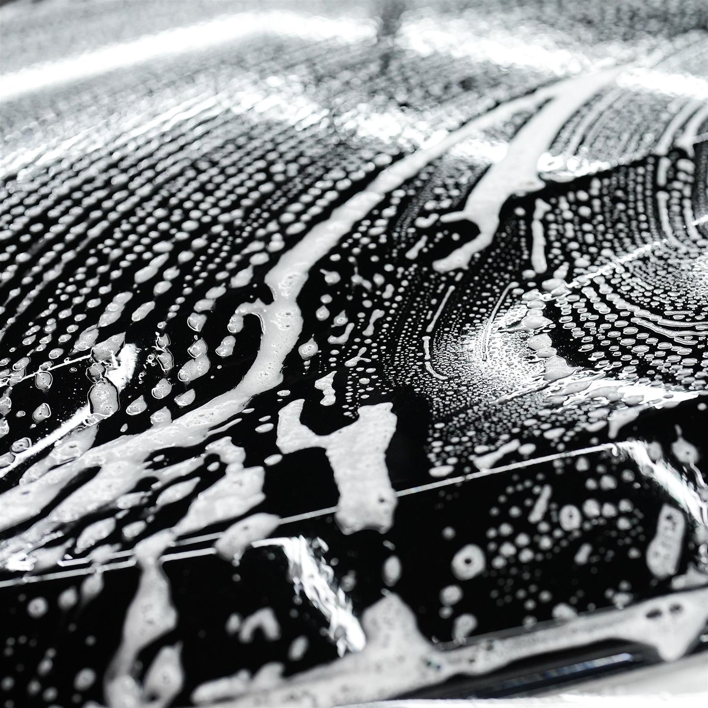 Car care: Suds coat a dark vehicle. Wash and wax for a shiny finish.