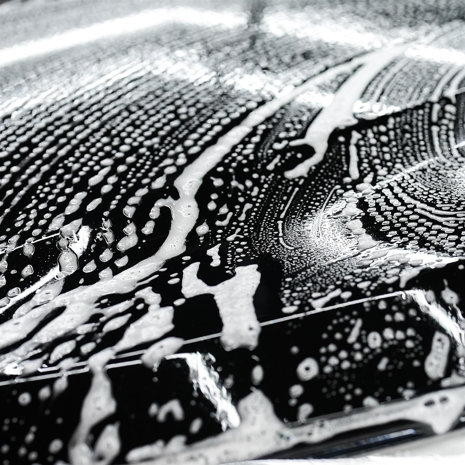 Car care: Suds coat a dark vehicle. Wash and wax for a shiny finish.