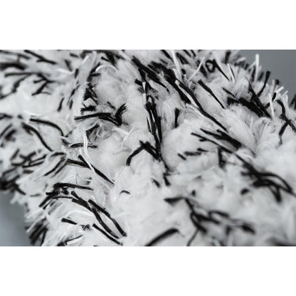 Close-up on a fluffy, white wheel cleaning brush with black filaments. Auto detailing equipment.