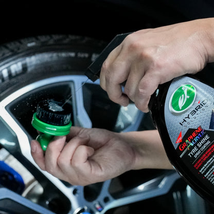 Car detailing: Turtle Wax Graphene Acrylic Tyre Shine being applied to a brush for cleaning car tyres.
