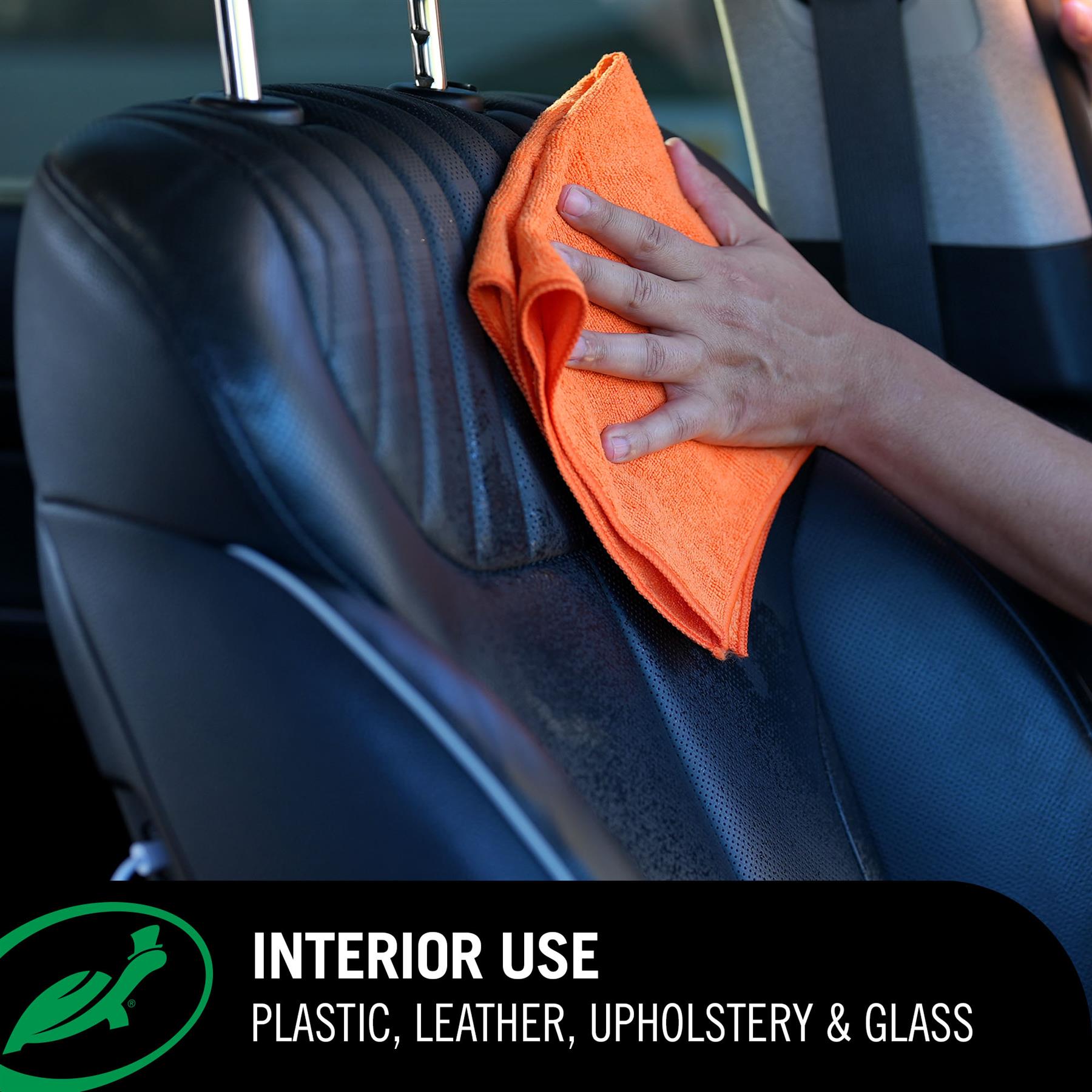 Person cleaning a car seat with an orange cloth inside a vehicle, with text indicating interior use for plastic, leather, upholstery, and glass.