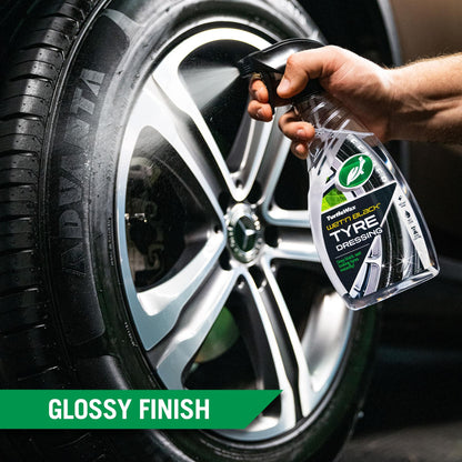 Turtle Wax Wet'n Black Tyre Dressing being sprayed on a car tyre to give it a deep black, glossy finish for a showroom shine.