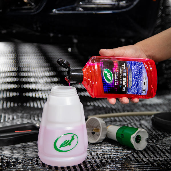 A hand pours the red liquid of Pure Seal into the Hybrid Solutions Pressure Sprayer bottle. 