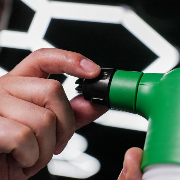 Close-up shot: Green spray nozzle adjustment for car detailing. Apply car cleaning products and Turtle Wax for a perfect finish.
