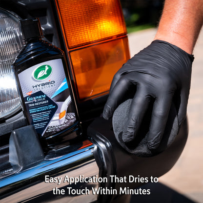 Turtle Wax Hybrid Solutions Graphene Acrylic Trim Restorer being applied to car trim. Restores & protects faded exterior plastic.
