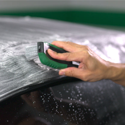 A hand uses an applicator on a fabric car roof. Cleaning solution shown. Hybrid Solutions by Turtle Wax.