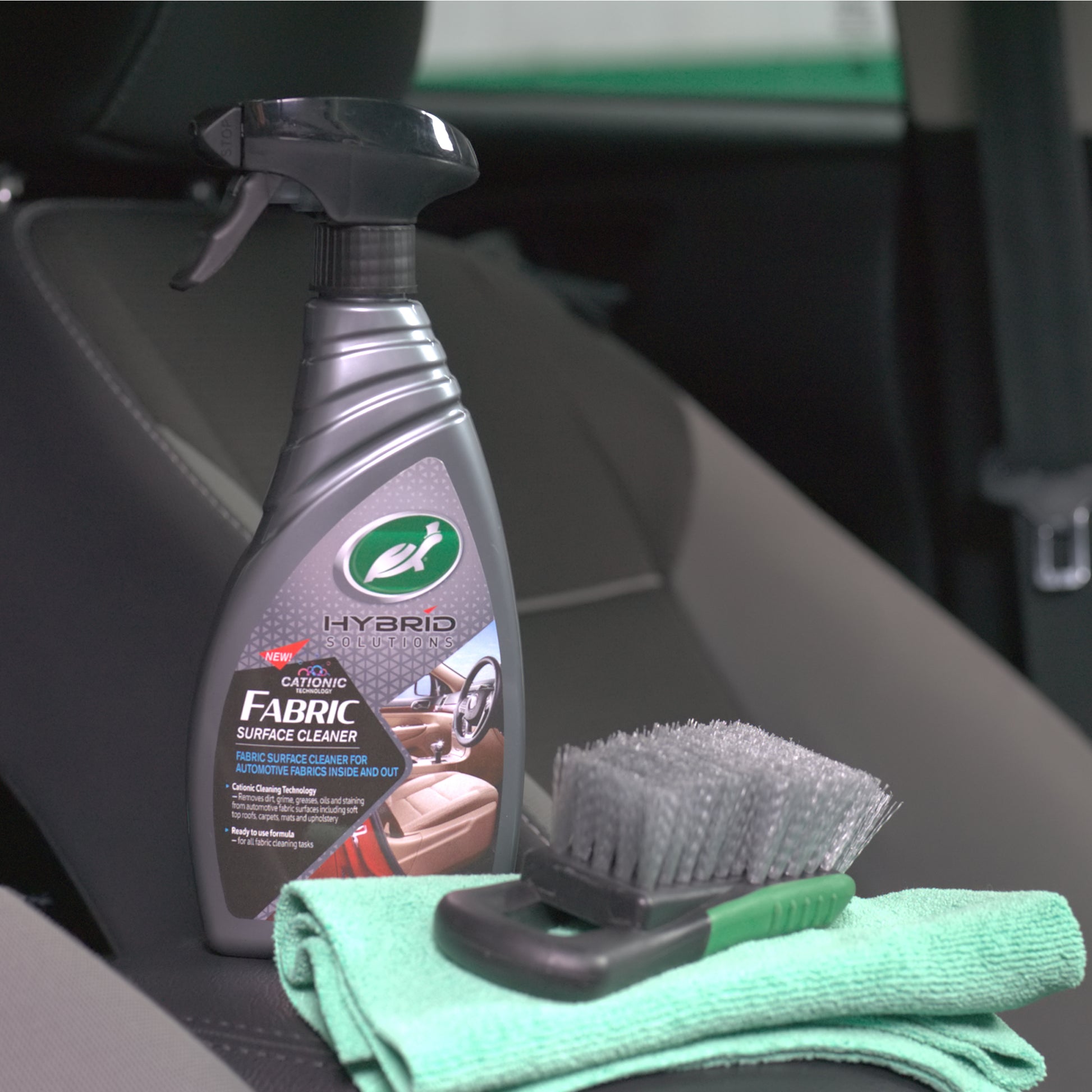 Turtle Wax Hybrid Solutions fabric cleaner shown with brush and cloth. Car upholstery care for interiors/ exteriors.