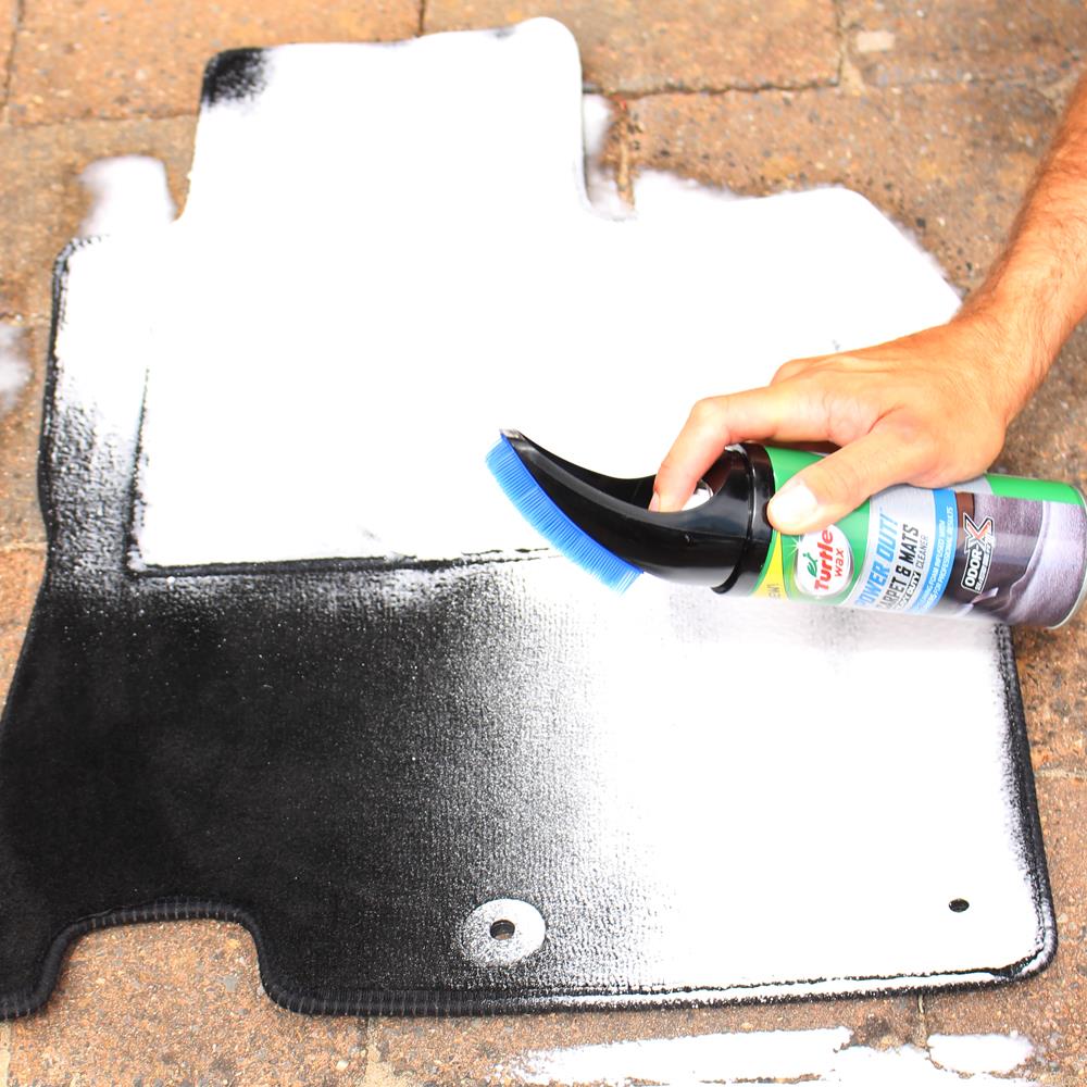 Dirty car mats being cleaned with Turtle Wax foam and brush attachment. Car care and auto detailing in the UK.