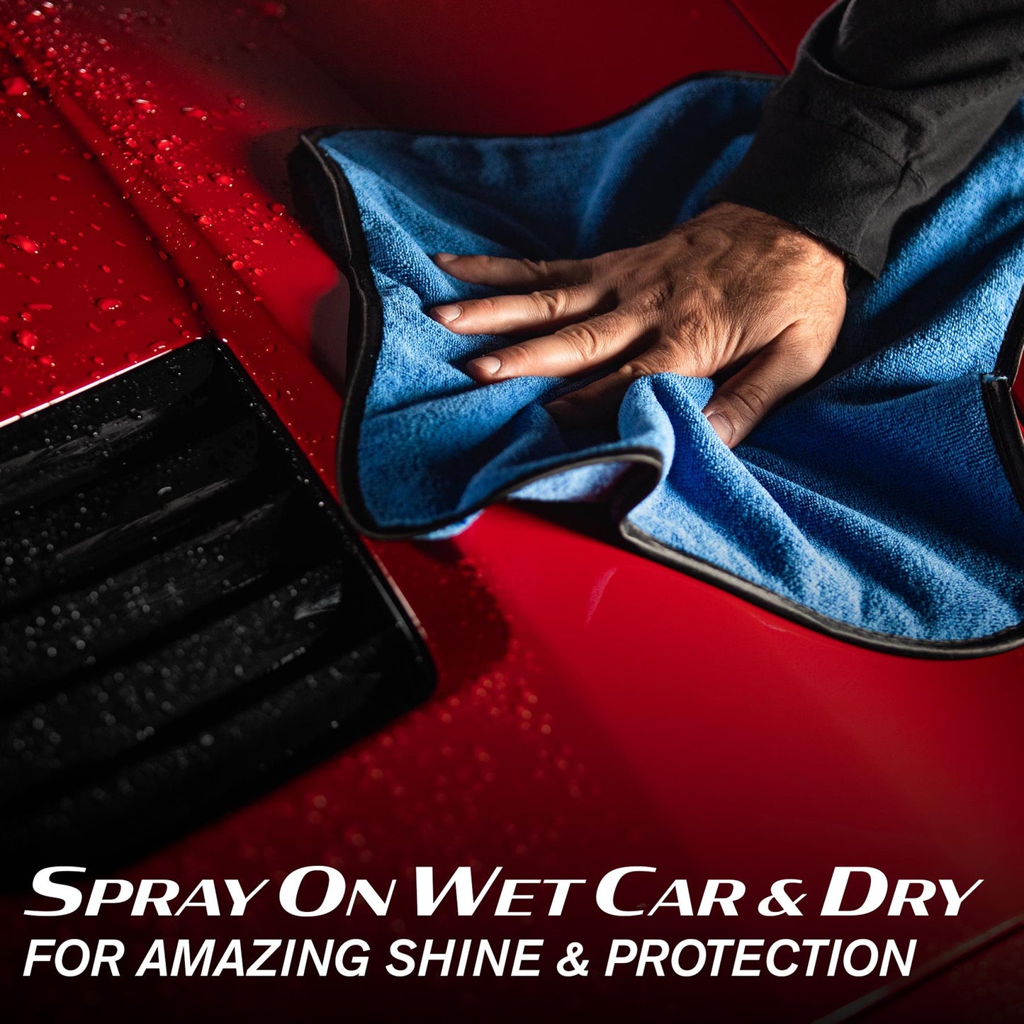 Detailing a red car with Turtle Wax products. Microfibre cloth polishing wet surface for a protective ceramic finish.