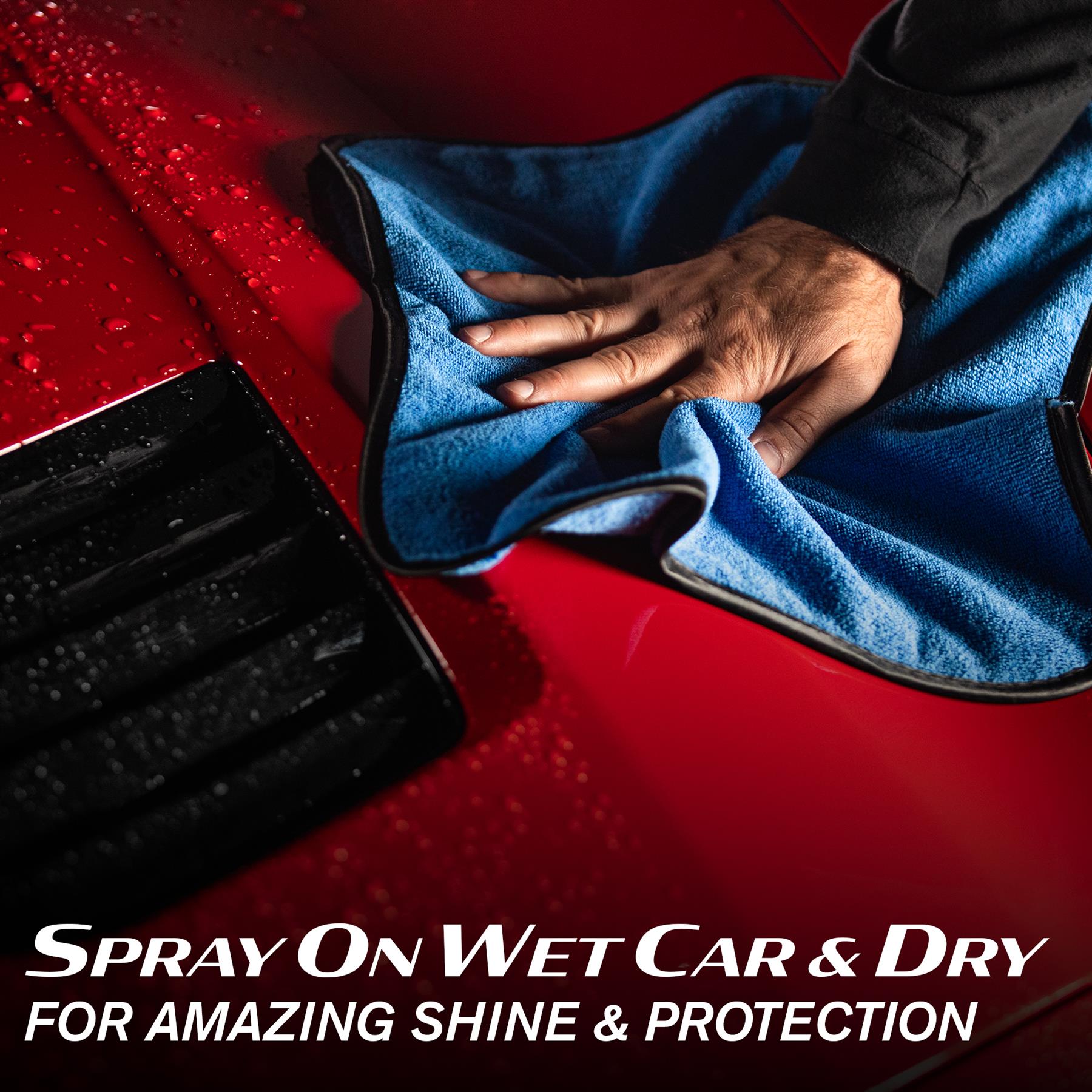 Detailing a red car with Turtle Wax products. Microfibre cloth polishing wet surface for a protective ceramic finish.