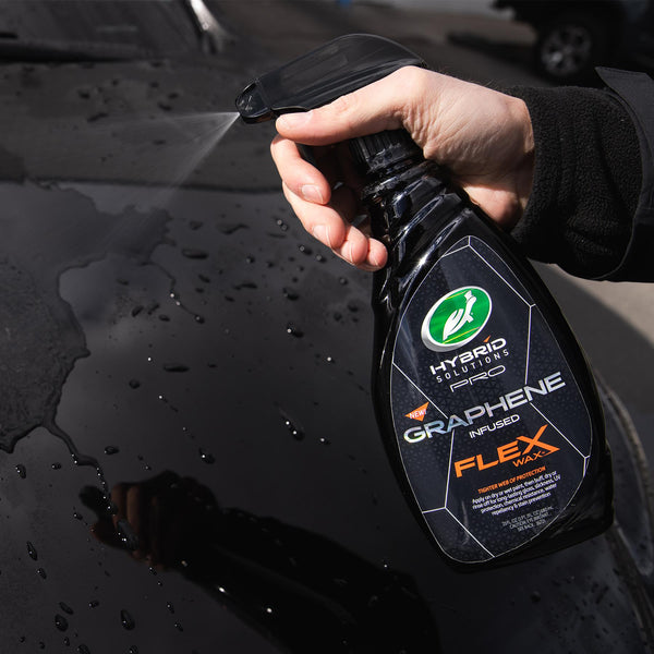 Detail shot of Hybrid Solutions PRO 1 & Done product being applied to a vehicleâ€™s surface using a microfiber applicator, emphasizing texture and technique.