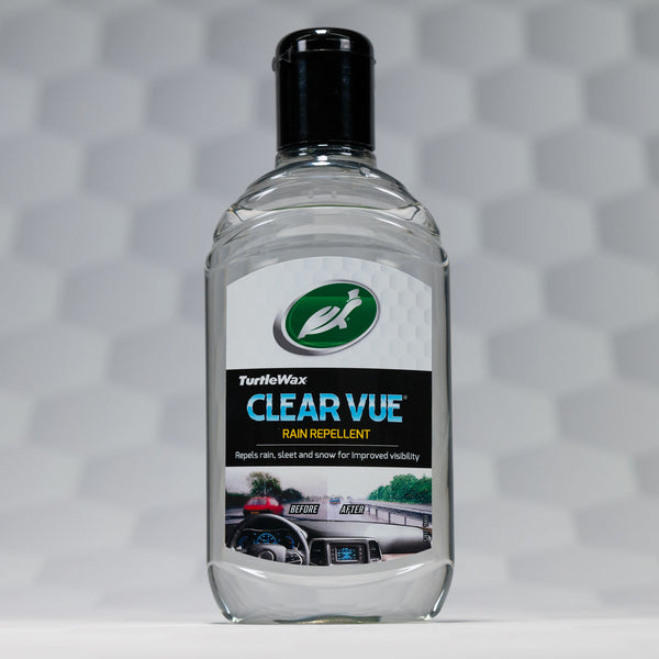 Detailed shot of a dashboard cleaner spray, focusing on the label's features and the spray nozzle design, placed on a car dashboard to indicate its intended use.