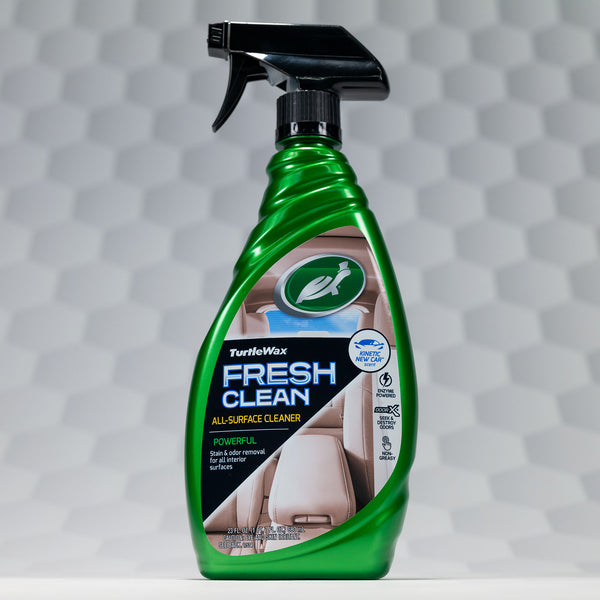 Detailed shot of Fresh Clean used on car door panel to remove dust and dirt with a clean microfiber cloth.